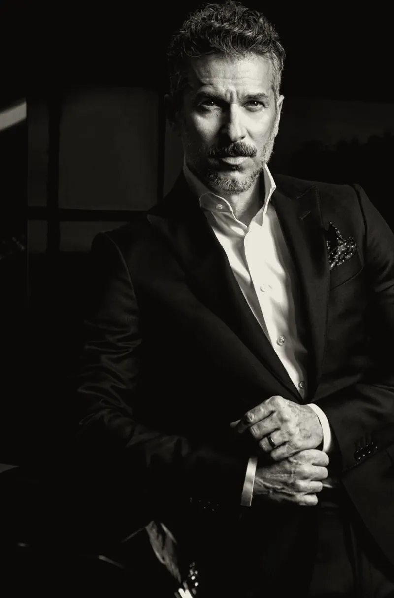 A man in a dark suit, black-and-white portrait
